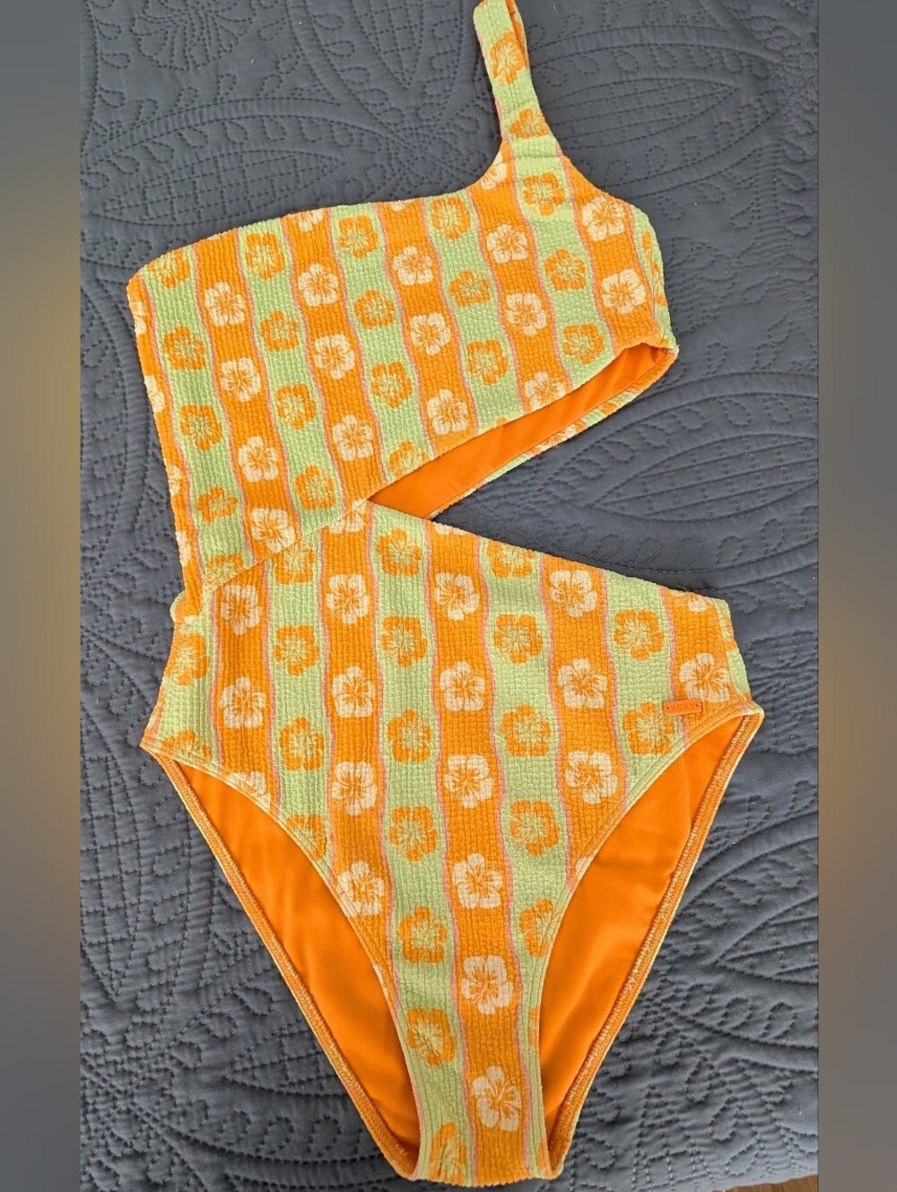 Roxy one shoulder swimsuit with orange and light green floral pattern